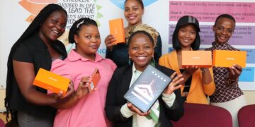 Figure 1 SOS Children's Villages Communication’s Coordinator Temalangeni Dlamini holding a rugged tablet , together with the SOS team and the OUKITEL representatives, Esihle Dlamini and Zanzi Nxumalo.