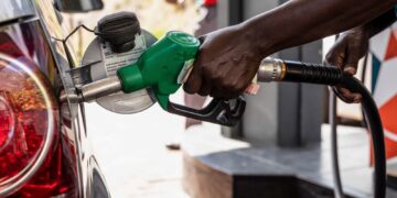 Fuel attendant refueling a car at the station.