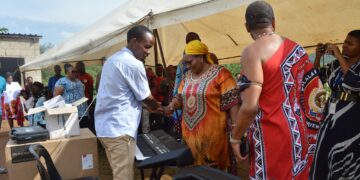 Deputy Prime Minister Thulisile Dladla hands over musical instruments to Nkosenomusa Sibaya Gamedze, a visually impaired musician, in a gesture of support for his musical career.