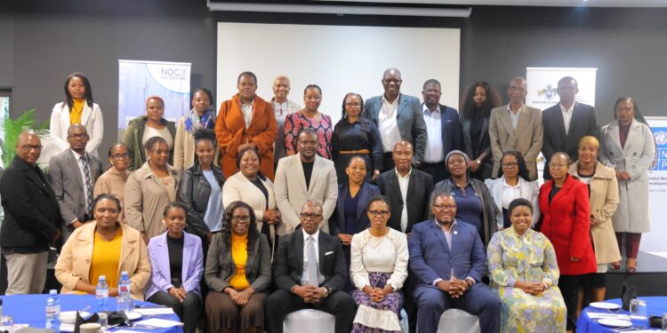 Stakeholders engage during the NDC 3.0 revision breakfast meeting in Mbabane.