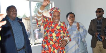 Deputy Prime Minister Thulisile Dladla hands over house keys to Gogo Khumbulile Dlamini in Mpolonjeni, one of four beneficiaries of newly built homes in the Hhohho region. Looking on are Motshane MP Wilton Nkambule and NDMA officials.