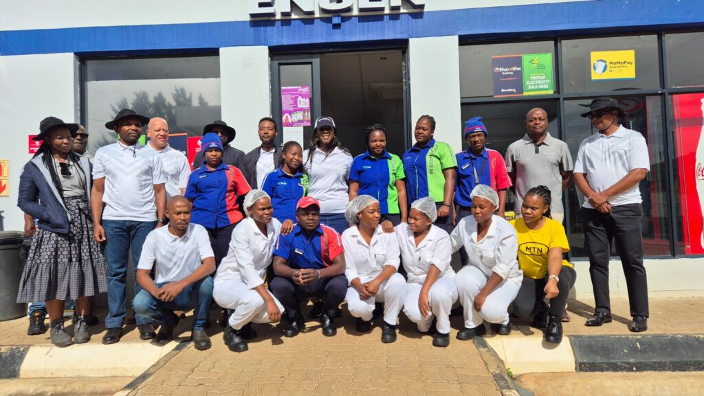 Eswatini Bank Managing Director Noziziwe Mulela and Board Chairman Dumisani Mahlindza pose with staff at the Engen Filling Station