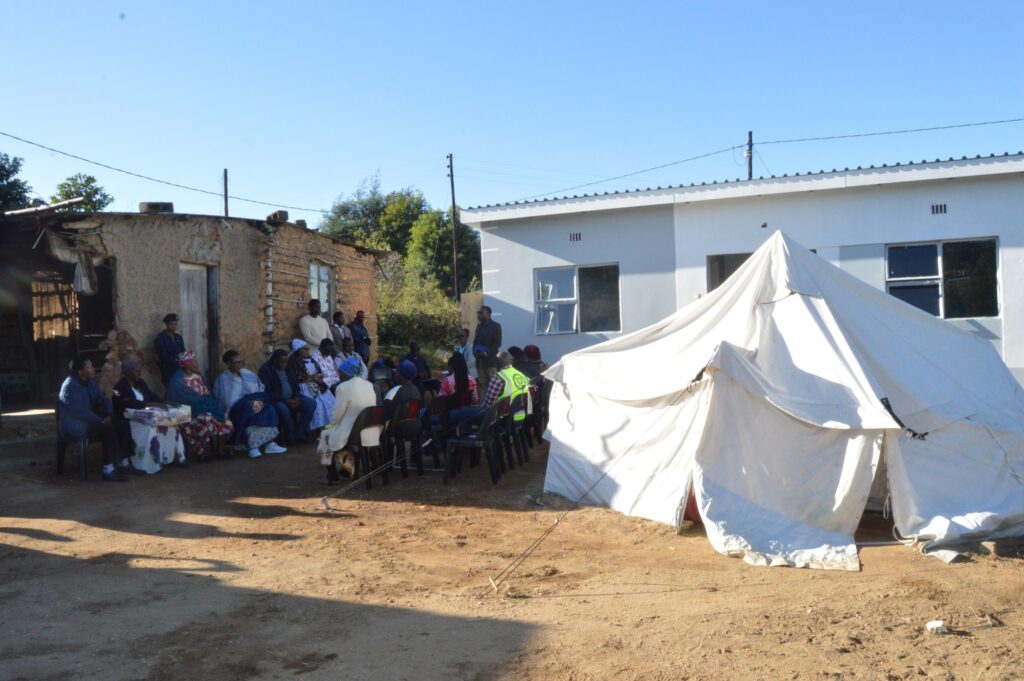 Deputy Prime Minister Thulisile Dladla hands over house keys to Gogo Khumbulile Dlamini in Mpolonjeni, one of four beneficiaries of newly built homes in the Hhohho region. Looking on are Motshane MP Wilton Nkambule and NDMA officials.