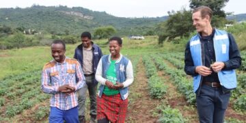 UNDP Resident Representative, Mr Henrik Franklin talks to the Malazas while touring their farm. UNDP/Mantoe Phakathi