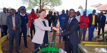 Minister of Agriculture Jabulani Mabuza and the European Union representative share a moment during the official handover of hay-making equipment worth E3.1 million at Mpisi Cattle Breeding Station.