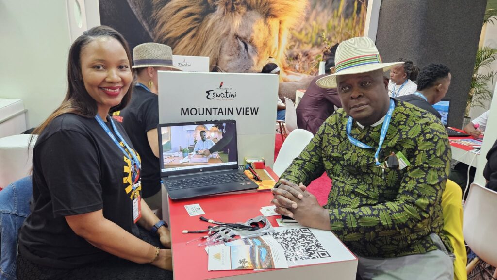 Tobi Motsa, Manager of Mountainview Hotel, shares a moment with a guest at the Eswatini stand during the Africa Travel Indaba.