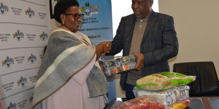 Deputy Prime Minister Thulisile Dladla receives food parcels from Reverend Johannes Mazibuko of Mbabane Alliance Church during the official handover ceremony at the DPM’s Office. The donation will support vulnerable communities across Eswatini. Photo by DPM Office