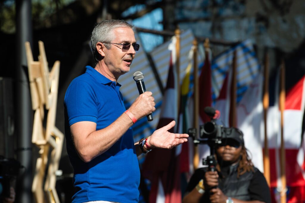 EU Ambassador to Eswatini, Karsten Mecklenburg, speaks during the official opening of the EU Bushfire Schools Festival 2025. Malkerns, Eswatini – 20250529 – School’s Festival, Bushfire 2025. Photo: Bram Lammers / MTN Bushfire