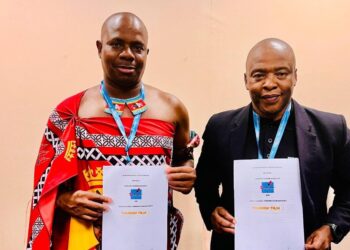 ETA CEO Vusie N. Dlamini and Acting KZN Tourism & Film CEO Dr. Sibusiso Gumbi shake hands after signing a tourism partnership agreement at Africa’s Travel Indaba in Durban.