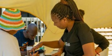A tourist receives assistance at the MTN stand to stay connected during the MTN Bushfire Festival.