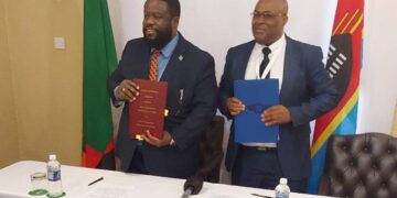 Thulani Mkhaliphi, Principal Secretary in the Ministry of Public Works and Transport, signs a bilateral air services agreement with a Zambian government representative during the Africa-Indian Ocean Aviation Week in Victoria Falls, Zimbabwe.