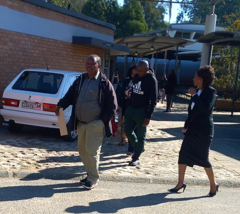 Sandile Mavimbela (centre) leaving the Mbabane Magistrate Court.