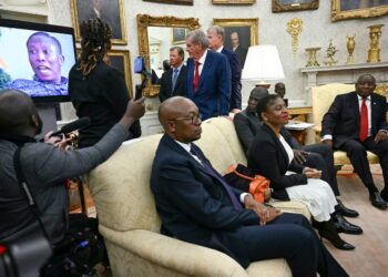 A video is played as South African President Cyril Ramaphosa, right, looks on during a meeting with President Donald Trump in the Oval Office of the White House in Washington, DC, on May 21. Jim Watson/AFP/Getty Images