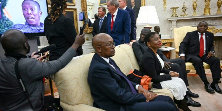A video is played as South African President Cyril Ramaphosa, right, looks on during a meeting with President Donald Trump in the Oval Office of the White House in Washington, DC, on May 21. Jim Watson/AFP/Getty Images