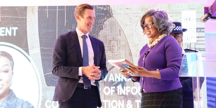 UNDP Resident Representative, Mr. Henrik Franklin, hands over the 2025 Human Development Report to the Minister of ICT, Hon. Savannah Maziya. UNDP/Thoba Dlamini