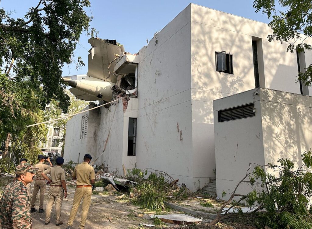A tail of an Air India Boeing 787 Dreamliner plane that crashed is seen stuck on a building after the incident in Ahmedabad, India, on Thursday. Amit Dave/Reuters