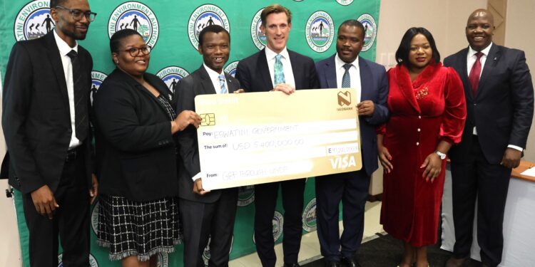 UNDP Resident Representative, Mr Henrik Franklin, assisted by GEF focal point, Ms. Khangeziwe Mabuza, hands over the cheque to the Acting Prime Minister, Hon. Appollo Maphalala. UNDP/Thoba Dlamini
