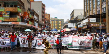 FILE PHOTO: Members of the South African anti-migrant group, operating under the slogan "Put South Africa First", take part in a peaceful campaign to force undocumented foreigners out of informal trading at Johannesburg's Hillbrow, an inner city suburb with a large population of African migrants, in Johannesburg, South Africa February 19, 2022. REUTERS/Siphiwe Sibeko/File Photo