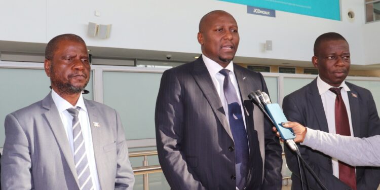 Prime Minister Russell Mmiso Dlamini, flanked by Minister of Agriculture Mandla Tshawuka (left) and Minister of Sports, Culture and Youth Affairs Bongani Nzima (right), speaks to the media before departing for Luanda, Angola, to attend the US-Africa Business Summit.