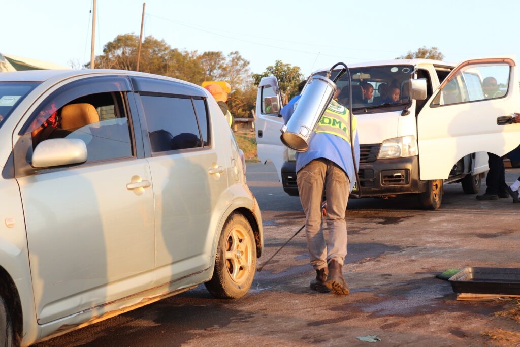 A worker sprays a vehicle at a disease control checkpoint in Shiselweni to prevent the spread of foot and mouth disease.