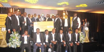 Nsingizini Hotspurs players and officials pose with the MTN CEO and Minister of Sports, Culture and Youth Affairs during the league title celebration at the MTN PLE Awards Ceremony. Photo by EFA