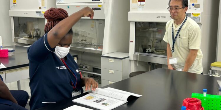 Ms Mawelela enjoying practical work under the watchful eye of a Japanese lecturer.