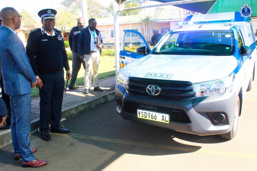 National Commissioner Manoma Vusie Masango and Ubombo Sugar Director Muzi Siyaya stand beside the newly donated patrol vehicle during the handover ceremony in Lubombo.