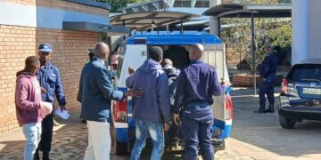 The suspects being assisted to get into the police van before they are taken to a correctional facility. (Pics: Lindelwa Myeni)