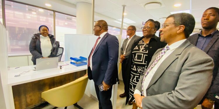Minister of Commerce, Industry and Trade Manqoba Khumalo tours the BOSS centre in Mbabane as officials from EIPA