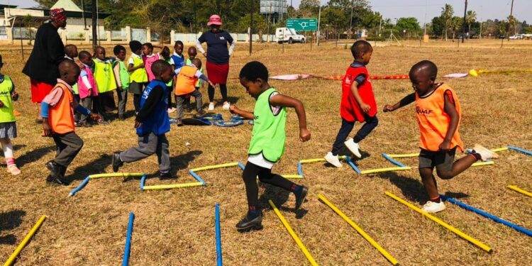 Young athletes enjoy a fun relay race during the Kids Athletics event at Olympafrica Centre in Lobamba. Photo by AE