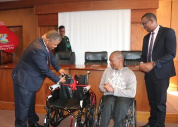 Ndumiso Bhembe beams with gratitude after receiving a new wheelchair, presented by Reverend Dr. Chong-Yang Kim at UNESWA, with support from Care for Someone Eswatini, the Student Counselling Office, and SRC.
