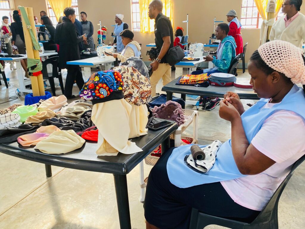Vukani Bomake women busy at work inside the Lobamba Lomdzala cottage factory, producing locally made clothing and accessories.