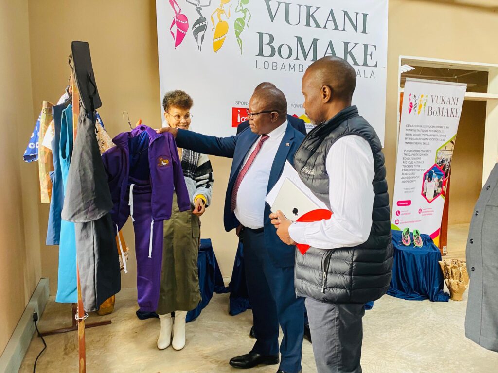 Minister Manqoba Khumalo inspects some of the handcrafted garments produced by the women of Vukani Bomake at the newly launched factory.