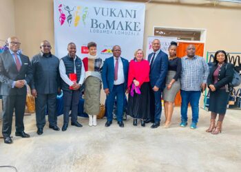 Minister of Commerce, Industry and Trade Manqoba Khumalo poses with members of the Vukani Bomake group, community leaders, and partners during the launch of the cottage factory in Lobamba Lomdzala.