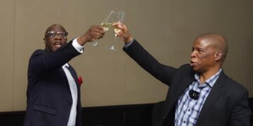 EWADE CEO Samson Sithole and Director of Corporate Services John Nsibande raise a toast to the team during the mid-term Vusela, marking key milestones in the 2022–2027 strategy.