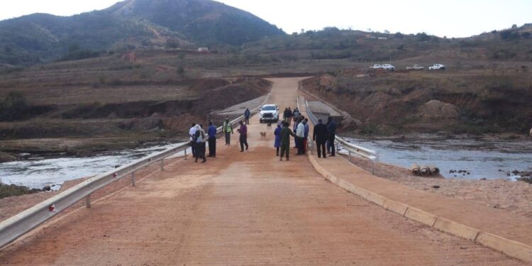 Community members of Mbangweni gather on the newly completed bridge connecting Nsingweni and Vusweni, officially opened by the Ministry of Economic Planning and Development under the Microprojects Programme.
