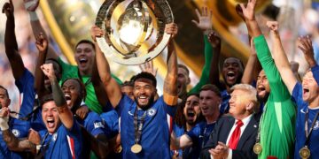 Chelsea players celebrate with the trophy after defeating Paris Saint-Germain to win the 2025 FIFA Club World Cup in New Jersey.