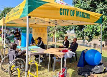 A participant with a disability engages with consultants during the Eswatini Career Expo 2025 at Mavuso Trade Centre.