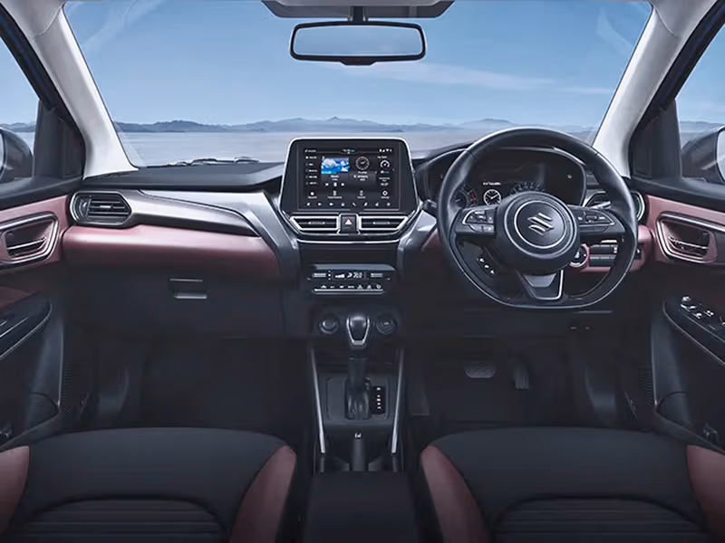 Inside the Fronx, a modern cabin features a touchscreen infotainment system, leather-trimmed steering wheel, and thoughtful driver comforts.