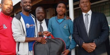 Sibonelo ‘Mzala’ Vilakati of Mpaka High School receives a new suit from Mywardrobe Eswatini Exclusive Suits director Linda Malindzisa, joined by head teacher Mfanzile Bhembe, deputy head Bongani Makhanyana, and ESSA Treasurer Lucky Dlamini.