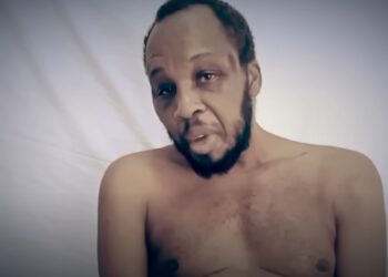 Jerry Boshoga seen in a distressing video screenshot from the Cutting Edge documentary, pleading for his life during captivity.