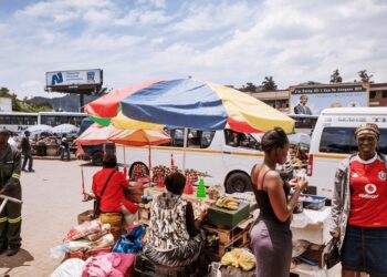 Commuters go about their day at the bustling Mbabane Bus Rank, one of the capital’s busiest transport hubs. photo by Jeroen Swolfs