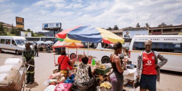 Commuters go about their day at the bustling Mbabane Bus Rank, one of the capital’s busiest transport hubs. photo by Jeroen Swolfs