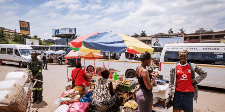 Commuters go about their day at the bustling Mbabane Bus Rank, one of the capital’s busiest transport hubs. photo by Jeroen Swolfs