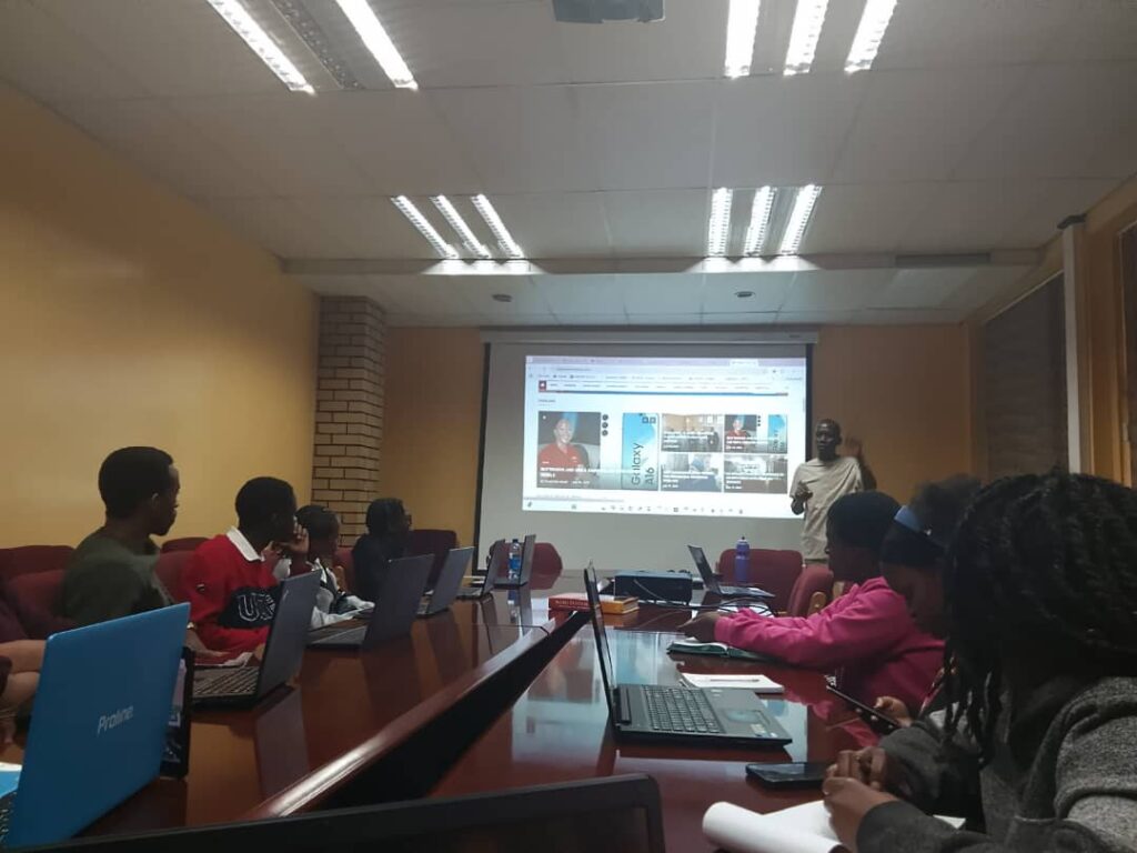 An instructor from Eswatini Tech Academy guides trainees through hands-on web development exercises, empowering youth with valuable freelance skills.