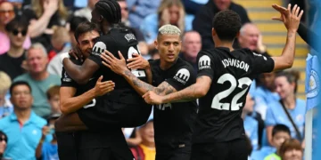 Joao Palhinha celebrates with teammates after scoring Spurs’ second goal at the Etihad Stadium