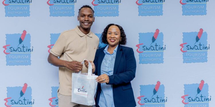 Sakhile Nkambule receives a gesture of appreciation from Eswatini Tourism’s Head of Marketing, Chunky Dlamini.