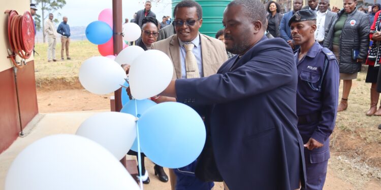 Minister S’khumbuzo Dlamini officially opens one of the newly completed projects by cutting the ribbon at Hluthi Central High School.