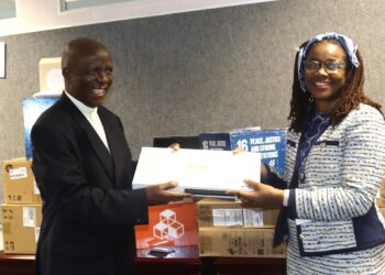Minister of Justice and Constitutional Affairs, Hon. Prince Simelane, receives IECMS equipment from UNDP Deputy Resident Representative Nessie Golakai-Gould at the ministry offices in Mbabane.