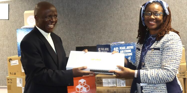 Minister of Justice and Constitutional Affairs, Hon. Prince Simelane, receives IECMS equipment from UNDP Deputy Resident Representative Nessie Golakai-Gould at the ministry offices in Mbabane.